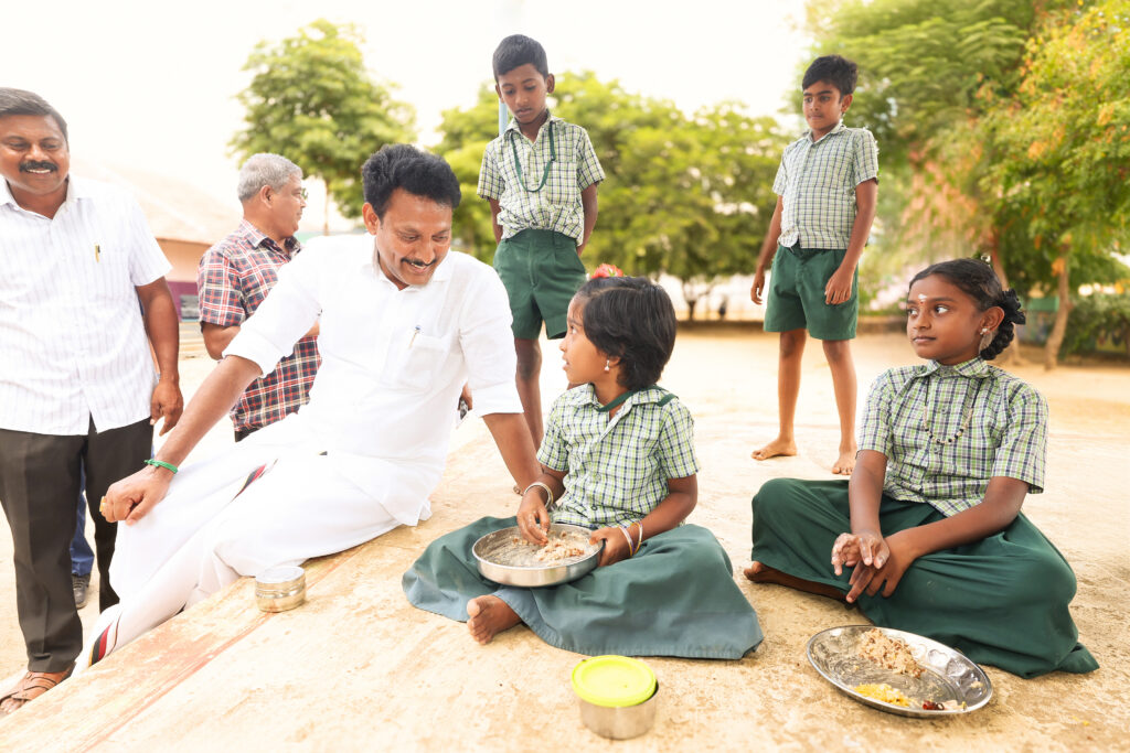 Minister interacting with kids during 234/77 visit