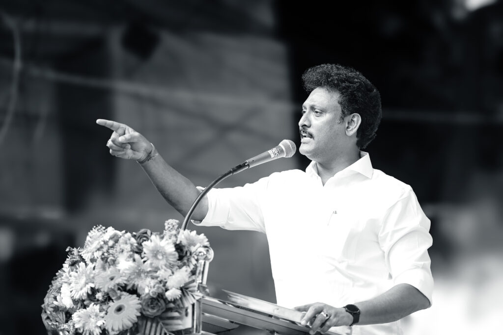 Minister Anbil Mahesh Poyyamozhi addressing the crowd in a political event