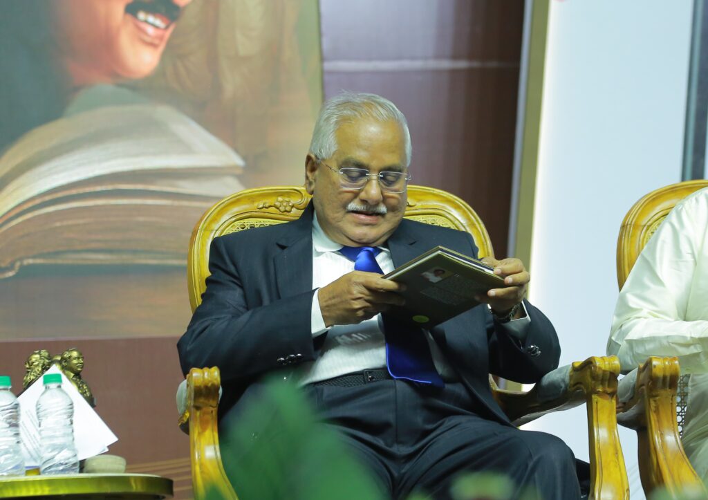 Former Chief Justice of Orissa High Court, V. Gopala Gowda, examines the bilingual book "Madhayaanai" at the release function.