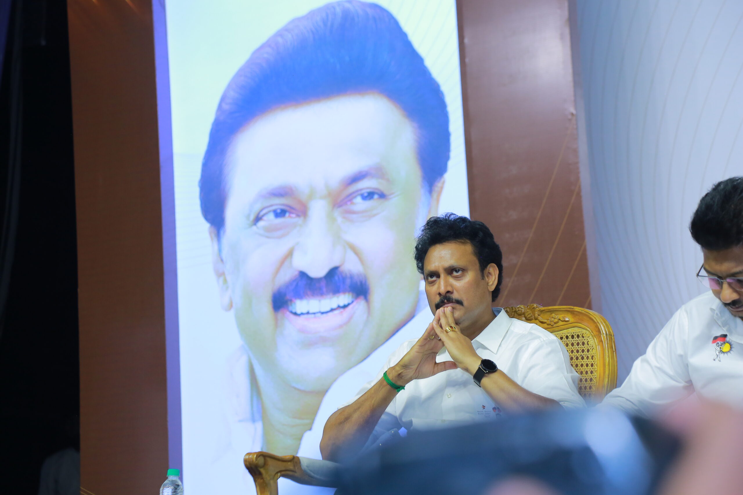 Tamil Nadu School Education Minister Anbil Mahesh Poyyamozhi and Youth Welfare Minister Udhayanidhi Stalin sit together at the Madhayaanai book release event, focused on the proceedings.