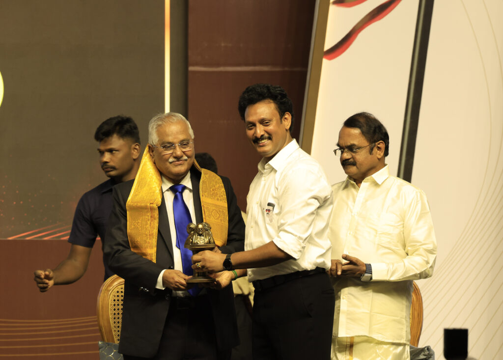 Minister Anbil Mahesh Poyyamozhi presenting a memento to Dr. V. Gopala Gowda, former Supreme Court judge, at the book launch event in Chennai.
