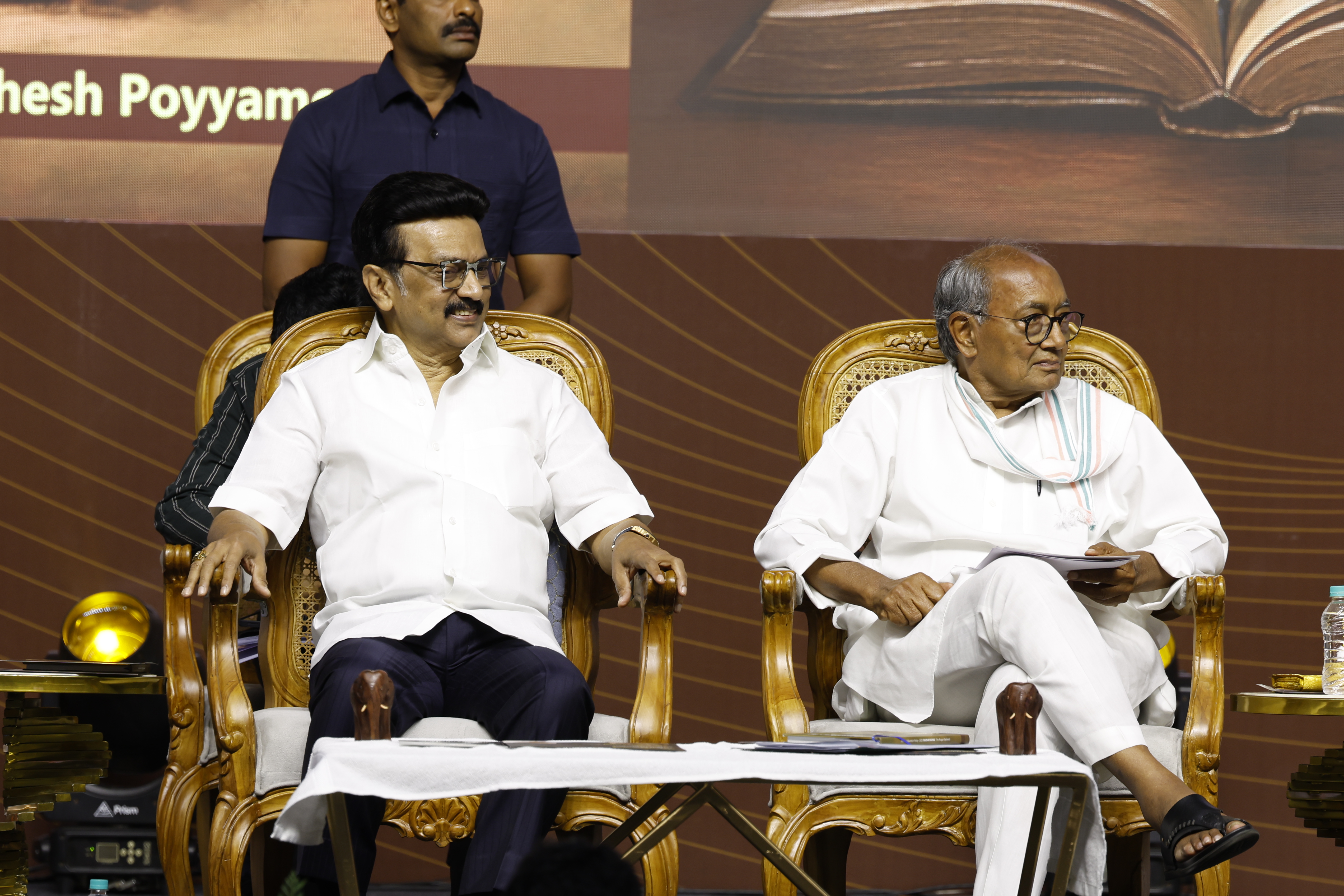 Chief Minister M. K. Stalin and senior Congress leader Digvijaya Singh seated on stage at the "Madhayaanai" book launch, engaging in a moment of reflection.