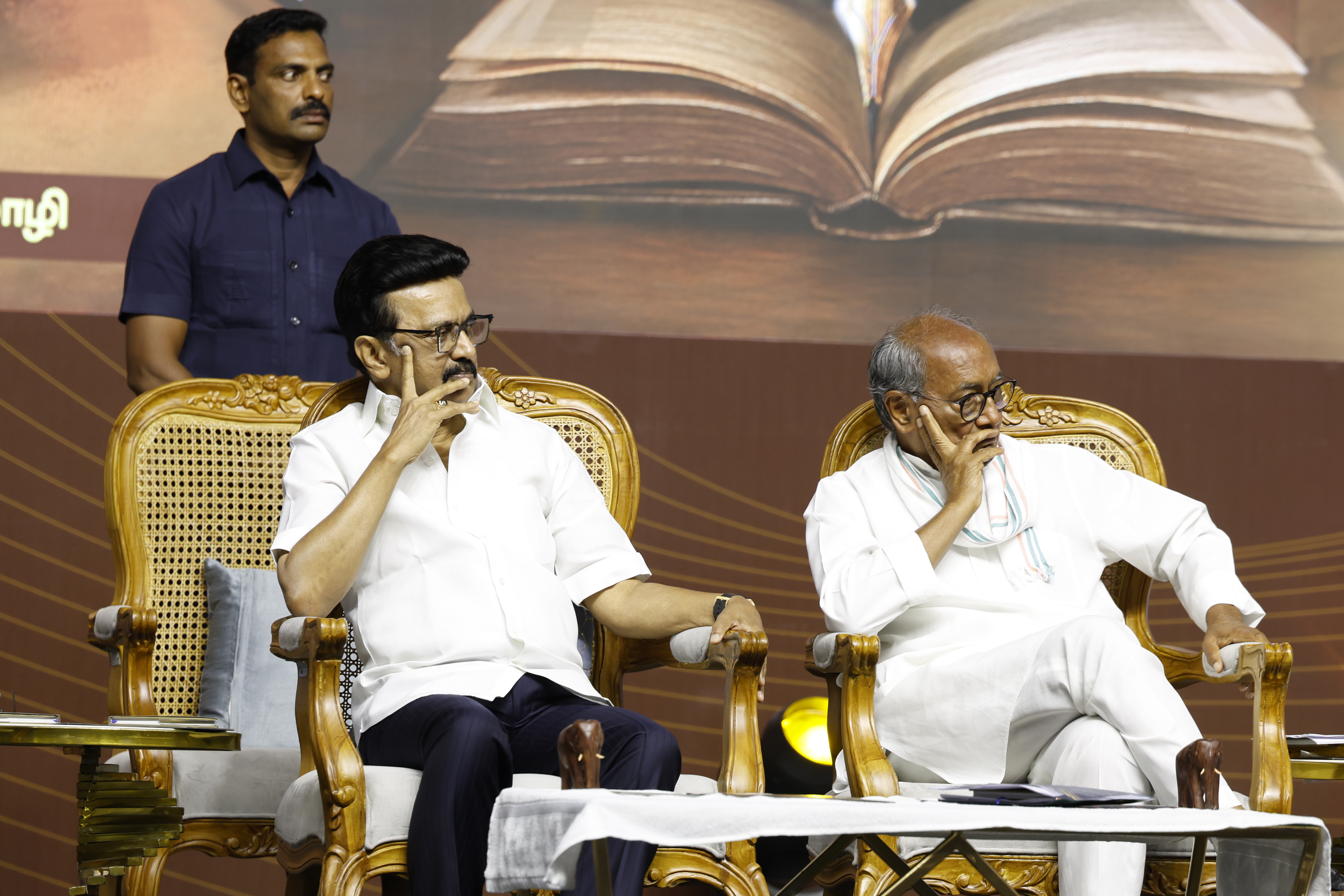 Chief Minister M. K. Stalin and senior Congress leader Digvijaya Singh seated on stage at the "Madhayaanai" book launch, engaging in a moment of reflection.