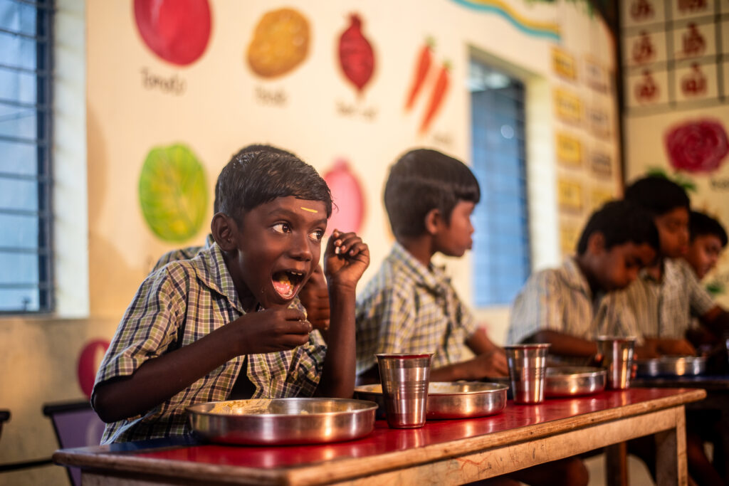 A school student enjoying CM breakfast at school
